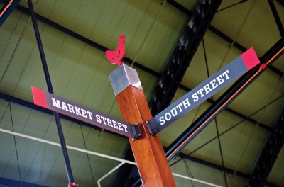 Indoor ‘street posts’ are topped with silhouette shapes representing different product sections of the market.