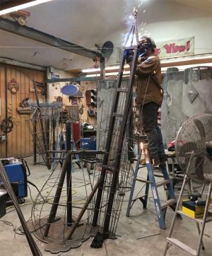 Often what is unseen and hidden inside sign pieces is as much work as the outside. Here, Matt Marriot welds the inner structure of the Penguin ice cream sign, which is engineered to make the city authorities happy. 