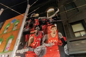 For this mural, Sekanskin wanted to go bigger than before—rather than just having Leonard—the new design featured all five starting players as well as Drake giving head coach Nick Nurse the much-publicized shoulder rub.