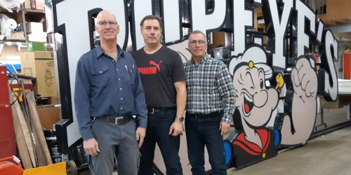 Modern Neon Signs recently celebrated its 50<sup>th</sup> anniversary. Pictured left to right are Claude, Marc, and René Pomerleau.