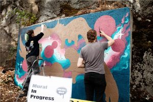 Kara Dee Harrison’s painting appears on a concrete slab embedded into the cliff face near 151 Front St. Her playful design features characters inspired by local marine life in her signature colours, turquoise and gold.