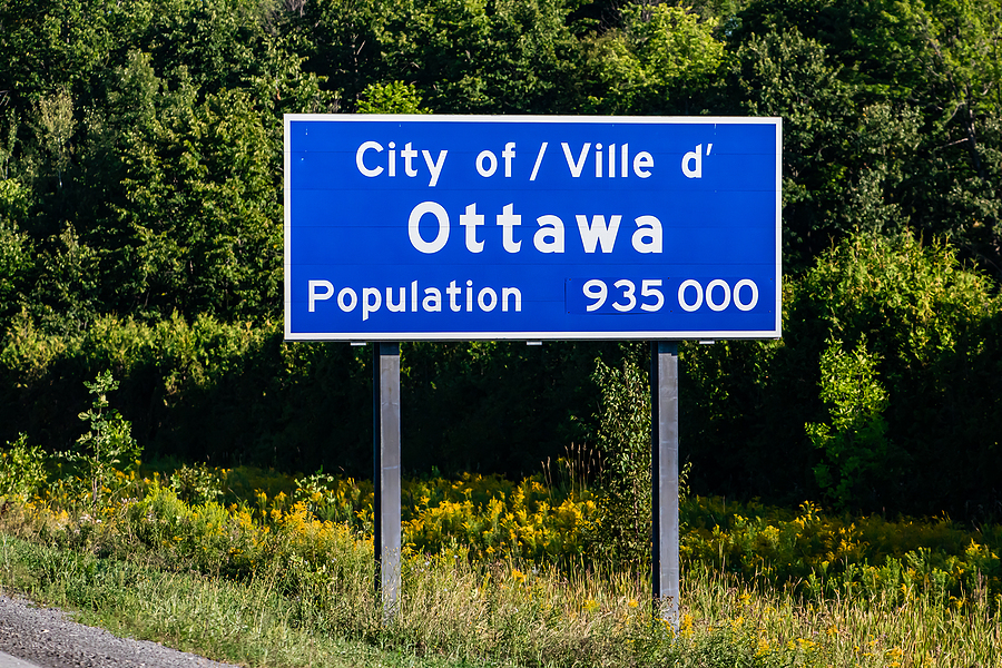 The sign marking the beginning of the city, written in two languages, English and French. 