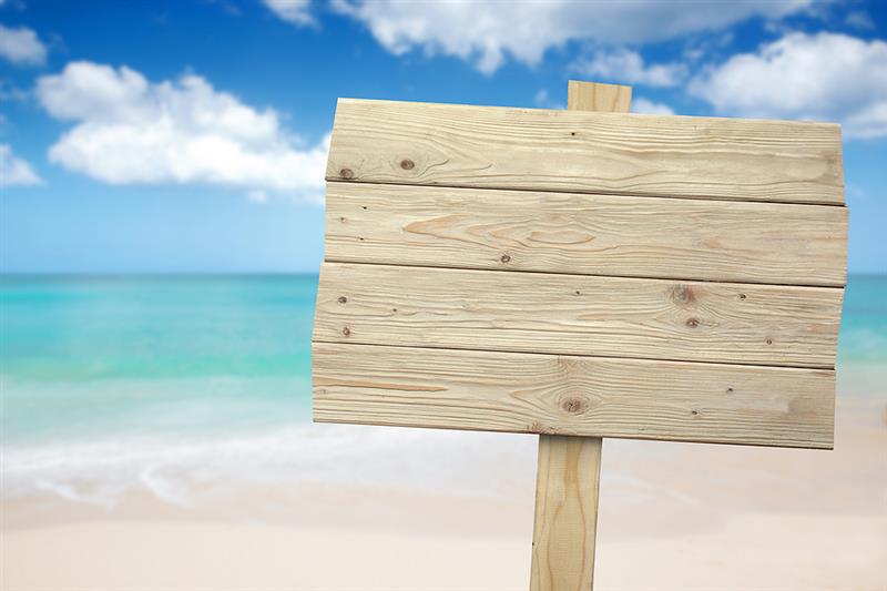 A sign board on a beach. 