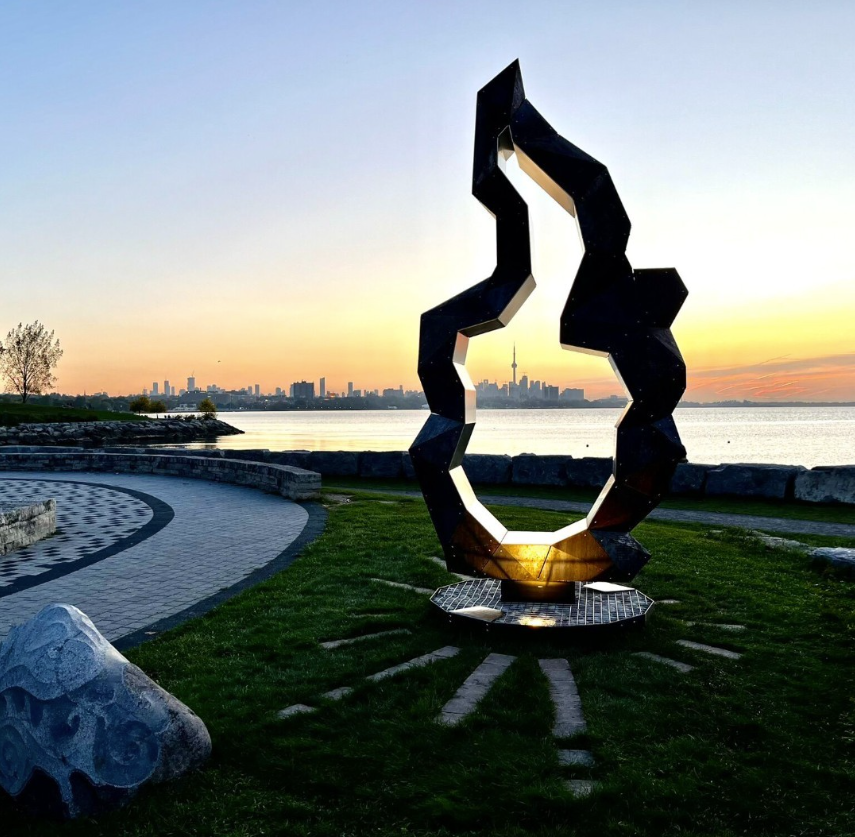 The monument in the foreground with the city skyline in the background. 