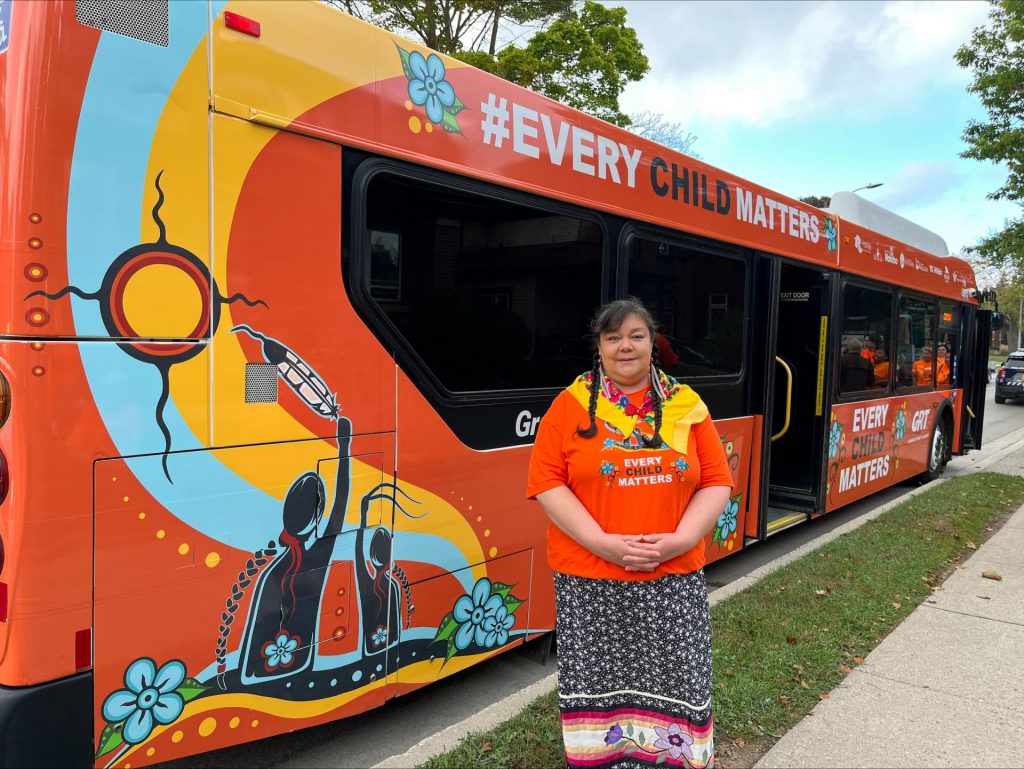 Judy Ross Mack stands in front of the bus for a photo.