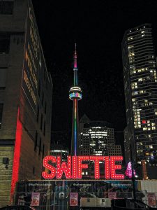 The SWIFTIE sign in the foreground with Toronto's famous CN Tower in the background. 